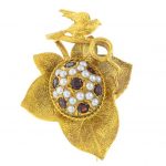 A mid 20th century 9ct gold garnet and split pearl brooch