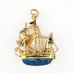 A Portuguese Gold Brooch / Pendant. 19 karat yellow gold ship form brooch / pendant
