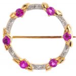 A 9ct gold sapphire and diamond brooch. Designed as a hoop